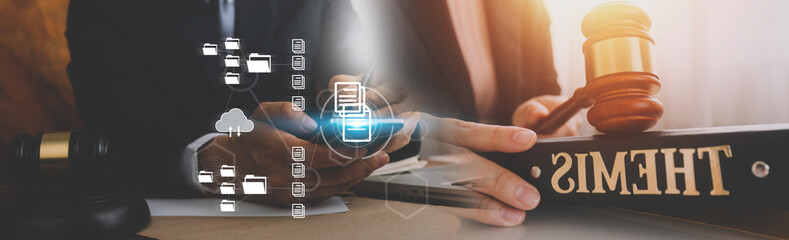 Justice and law concept.Male judge in a courtroom with the gavel, working with, computer and docking keyboard, eyeglasses, on table in morning light