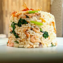 Asian fried rice with vegetable and ebi served on the plate.