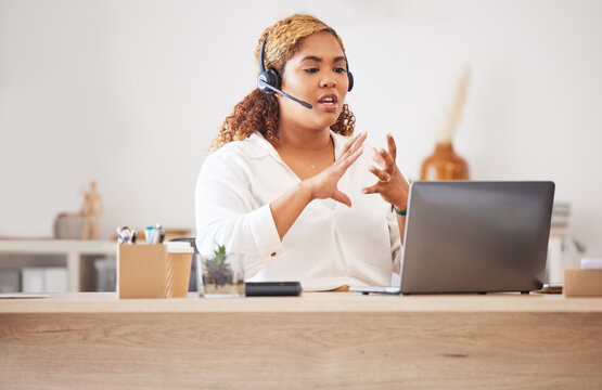 Female call center agent talking on headset while doing a video or zoom call and working in an office. Businesswoman consulting and explaining while on a call for customer sales and service support
