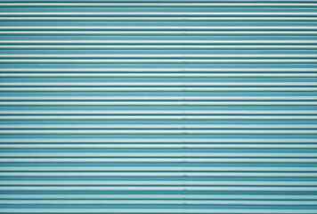 Corrugated metal roller shutter texture. Turquoise steel door for background.