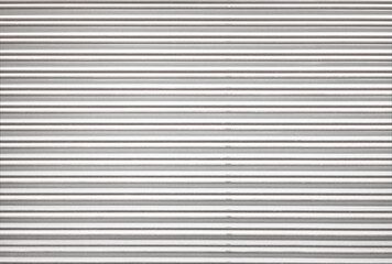 Obraz premium Corrugated metal roller shutter texture. Classic white steel door for background.
