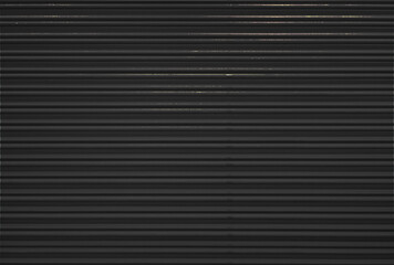 Corrugated metal roller shutter texture. Mat Black steel door for background.