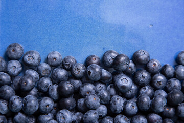 Blueberries occupied half of a blue flat plate