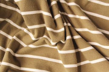 Green ocher crumpled fabric linen with white stripe for creative background. Copy space. Natural...