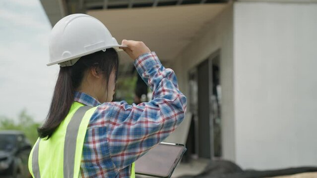 Real working engineering. Worker or engineering checking blueprint and planning to renovation, Female foreman in safety helmet and study blueprint for redecorating house. B roll slow motion 4k.