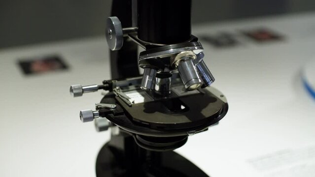 Closeup of a glass slide on an older optical microscope model