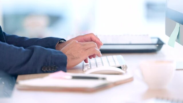 Closeup hands, typing on keyboard at modern office. Writing pen, checklist and entering data or information onto computer. Male planner speeding through daily tasks at the workplace