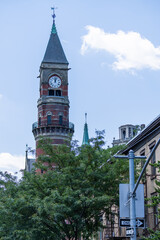 A clock towers rises above downtown Manhattan