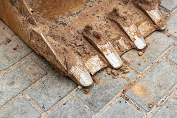 Close up of excavator bucket at construction site. Construction equipment for earthworks.