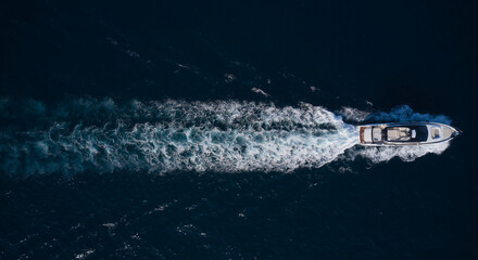 big mega yacht fast movement on dark water in the sea top view. Large super yacht In motion on dark...