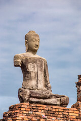 Fototapeta premium The broken Buddha statue in Wat Chaiwatthanaram. A Buddhist temple in the city of Ayutthaya Historical Park, Thailand, on the west bank of the Chao Phraya River. was constructed in 1630 by the king. 