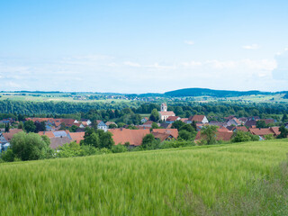 Fototapeta na wymiar Black Forest, Germany - May 29th 2022: View over the hills towards the beautiful village Muenchingen.