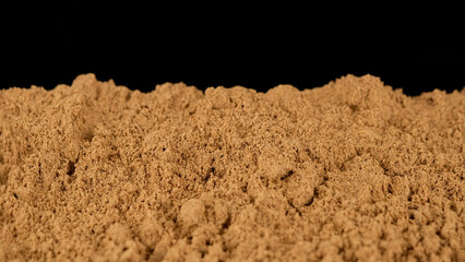 Cinnamon powder on black background