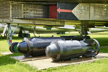 heavy bombs on the airfield under the fuselage of a bomber