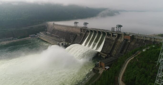 Power industry. Industry. Impressive view of the hydroelectric dam. Powerful discharge of water at the hydroelectric station. Amazing shots of huge platinum. Siberia, the Yenisei river. Krasnoyarsk.