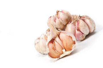 Several large heads of garlic, shot against a white background.