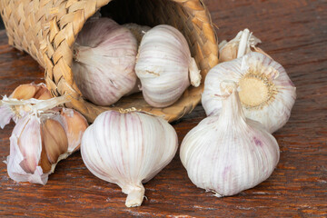 Garlic bulbs on wooden background.
