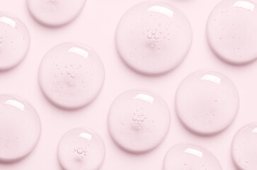 Pink drops of gel closeup. Cosmetic product for moisturizing the skin of the face or body.