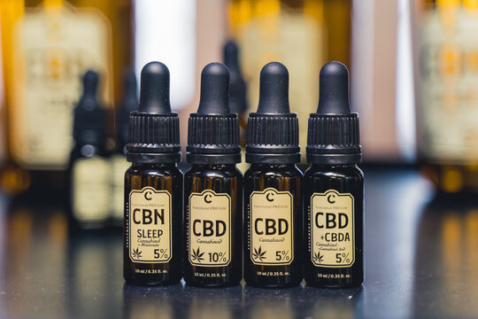 05.28.2022 Warsaw, Poland. Professional dark-glass bottles of CBD, CBN, and CBDA cannabis with various cannabidiol concentration. High quality photo