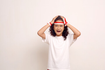 Surprised excited asian girl standing while holding her head. Indonesian independence concept