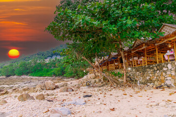 Colourful Skies Sunset over Kalim Beach Patong Pa Tong Beach in Phuket island Thailand. Lovely turquoise blue waters, lush green mountains colourful skies