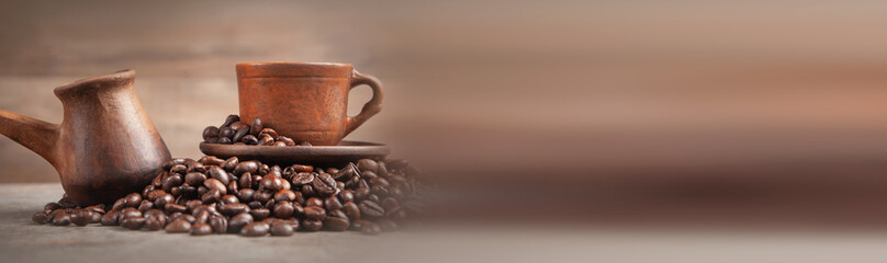  Clay coffee cup and pot on coffee beans.