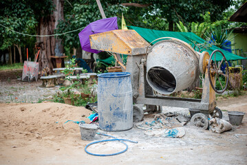 The yellow mortar mixer that has been used for many jobs has a lot of cement stains on it. and many...