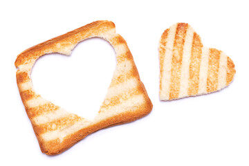 Toasted bread with grill marks and heart shaped hole isolated on white background