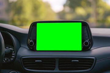 Close up display with green screen on car panel, car driving with navigation concept, blank screen dashboard.