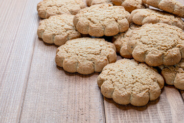 a large stack of gluten free oatmeal cookies on a cutting board.