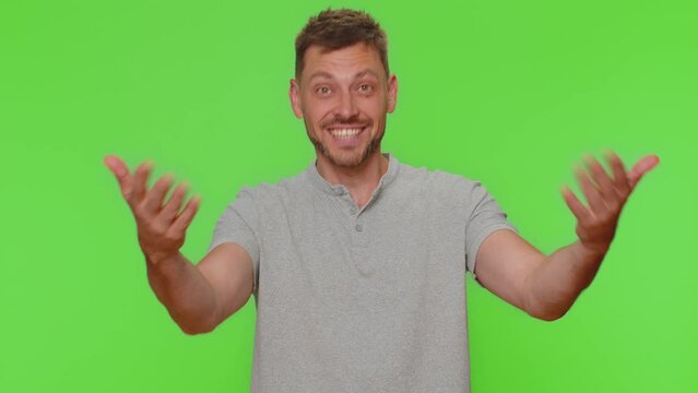 Come here, join us. Welcome. Bearded handsome man showing inviting gesture with hands, ask to join, beckoning to coming, gesturing hello or goodbye. Adult stylish guy isolated on chroma key background