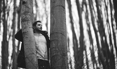 A man posing in the woods