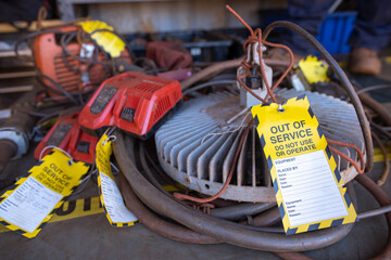 Safety workplaces yellow out of service tag attached on faulty damage defect unsafe to use of spot...