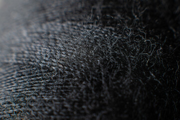Extremely close-up macro of the surface of a spool of thread in black. Low key. Selective focus. macro shot
