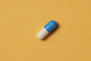 Medical pills on yellow background. Health care, pharmacy, drugs, medicine concept. Copy space for text.