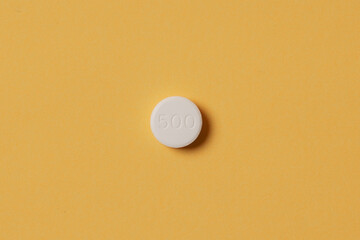 Medical pills on yellow background. Health care, pharmacy, drugs, medicine concept. Copy space for text.