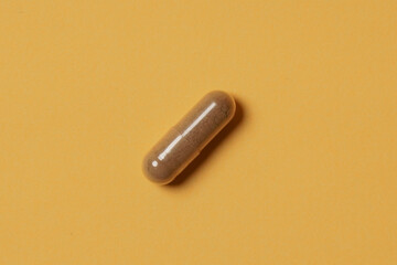 Medical pills on yellow background. Health care, pharmacy, drugs, medicine concept. Copy space for text.
