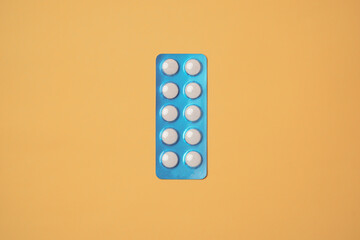 Medical pills on yellow background. Health care, pharmacy, drugs, medicine concept. Copy space for text.