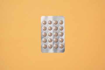 Medical pills on yellow background. Health care, pharmacy, drugs, medicine concept. Copy space for text.