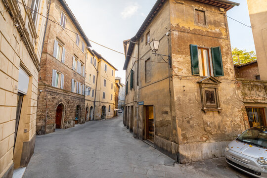 Fototapeta View on narrow and cozy street in the old town of Siena city in Italy. Concept of ancient architecture of the Tuscan region