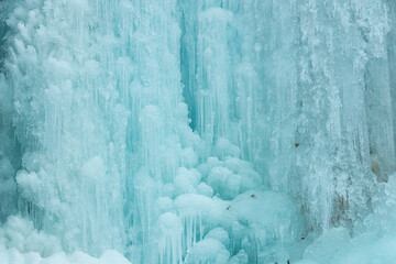 
Winter Scenery: Images from inside the frozen waterfall. It forms a beautiful ice cave, with flowing water and ice stalactites and stalagmites. Sharp details: clear and transparent ice.