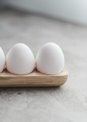 Eggs yolk white raw on grey background