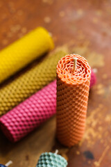 Wax decorative candles. Honeycomb candles. Multi-colored tall candles in the interior