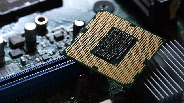 Detail of a CPU Processor over his Socket on a Motherboard. Printed Circuit Board - Computer Motherboard with Components. Shot with Rotation Movement