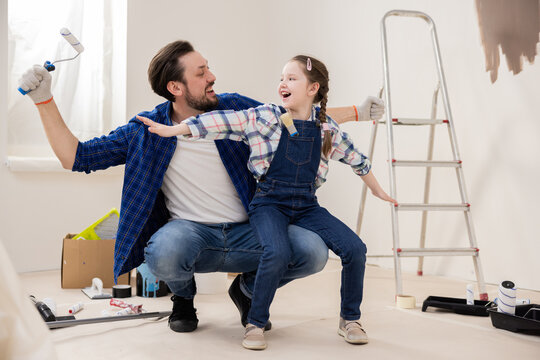 Dad and daughter play fun games in room under renovation. Husband is happy that he will finally be able to make daughter's wish come true - to make new nursery.
