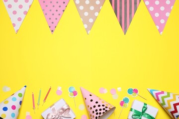 Obraz premium Flat lay composition with party decor on yellow background. Space for text