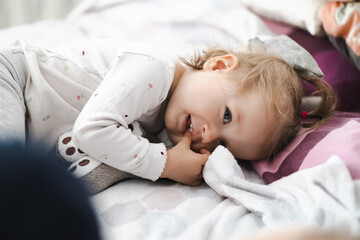 Fototapeta happy toddler girl in bed at home obraz