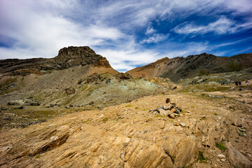 Excursion on the Gran Paradiso in the Alps. Walk in immense valleys and very high peaks above 3000m. Glacial lakes with crystal clear water and green meadows. The peaks crowned by huge rocks.