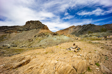 Excursion to the Gran Paradiso in the Alps. Search for rocks, minerals and precious stones. Study of the surface of rocks with sedimented debris over time. Lunar landscape, Martian landscape.