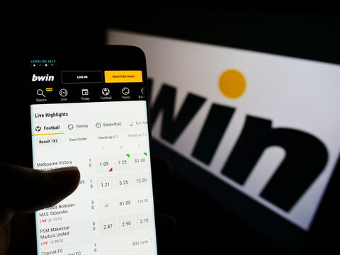 Stuttgart, Germany - 01-08-2022: Person holding cellphone with website of Austrian company bwin Interactive Entertainment AG on screen with logo. Focus on center of phone display.